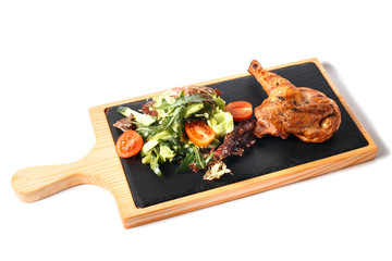 Grilled whole chicken in different variations with sliced cherry tomatoes, herbs, cut cucumber and salad on a wooden board and ceramic base. Traditional cuisine. Grill kitchen. Isolated on white