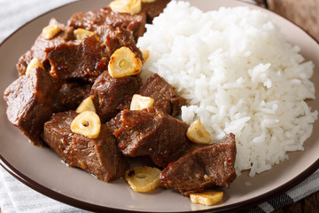 Filipino cuisine: beef Salpicao with rice garnish macro. horizontal
