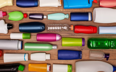 Colorful plastic bottles on wooden surface