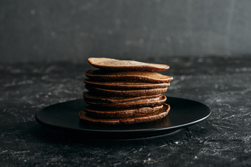 stack of delicious chocolate pancakes on black plate