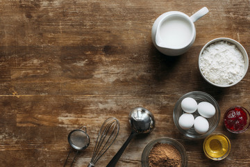 top view of fresh ingredients for pastry and utensils on wooden table