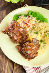 Pork spare ribs served with mashed potatoes and sauce