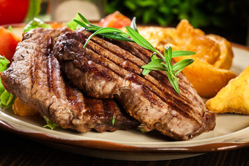 Succulent portions of grilled fillet mignon served with baked potatoes