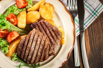 Succulent portions of grilled fillet mignon served with baked po