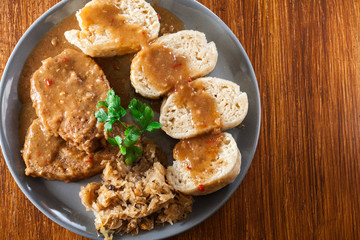 Pork loin in gravy with bread dumplings and sauerkraut