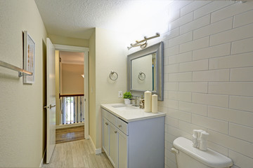 Freshly renovated bathroom features light blue bathroom vanity