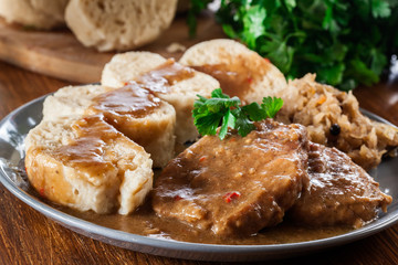 Pork loin in gravy with bread dumplings and sauerkraut