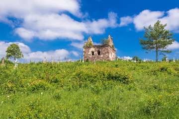 Old burial chapel on abandoned cemetery near Chervonohorod Castle ruins in Ukraine