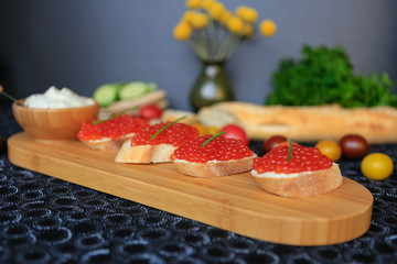 Close up of four sandwiches with red caviar
