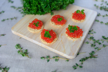 Closeup of red caviar appetizer served on crackers