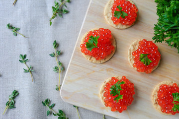 Closeup of red caviar appetizer served on crackers