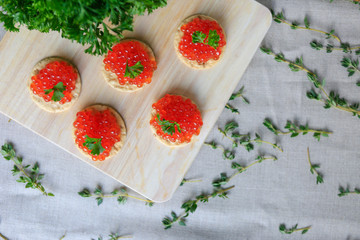 Closeup of red caviar appetizer served on crackers