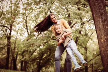Mother with her daughter in park.