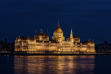 Obraz premium Budapest Parliament building and Danube river at night with illumination, travel sightseeing background