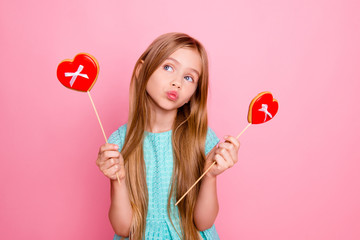 So cute, lovely and funny! Portrait of beautiful sweet girl wearing light blue dress, she is dreaming about confectionery and pastry, isolated on bright pink background