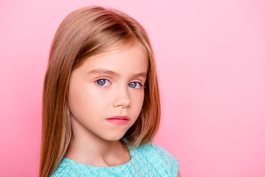 Close up portrait of cute nice lovely charming adorable beautiful confident concentrated little girl with big blue eyes, isolated on pink background, copyspace