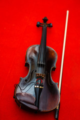 Old violin on a red background
