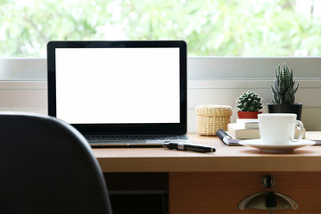 blank screen laptop on the desk at home office 
