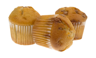 Side view of three bite size apple spice muffins with one on its side isolated on a white background.
