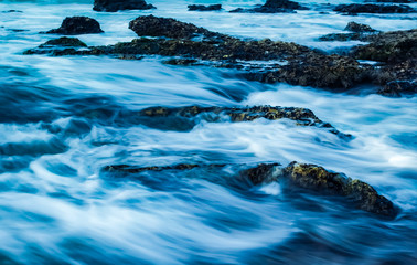 long exposure of rock pools by the beach