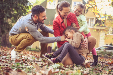 Smiling happy family playing outside.