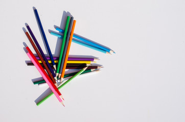 colored pencils on a white background