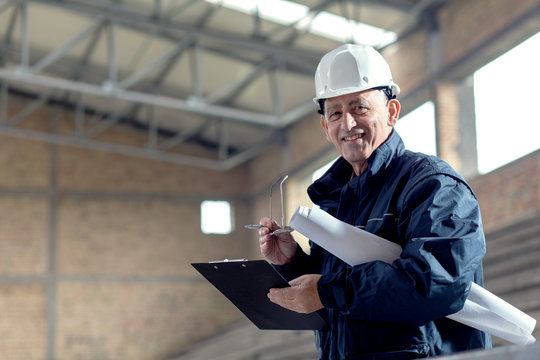 Senior construction manager controlling building site.