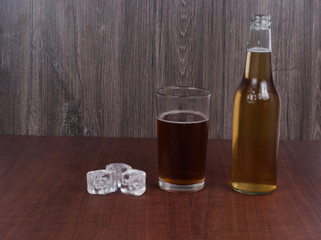 beer with ice on wooden background