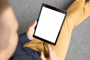 Man holding tablet in vertical position.