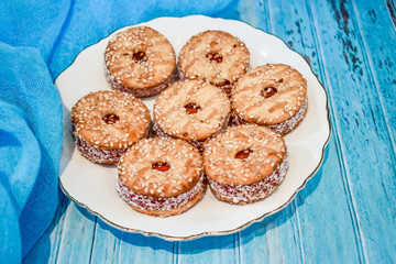 a plate with a shortbread cookie on a blue wooden background. Vegetarian breakfast.Top view