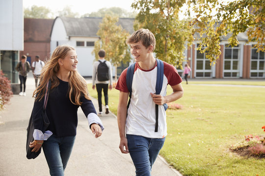 Teenage Students Walking Around College Campus Together