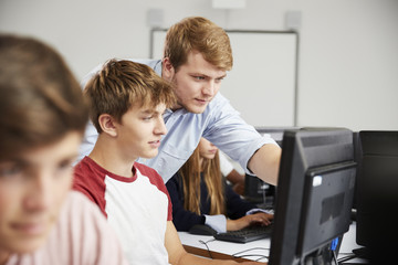 Teenage Students Studying In IT Class With Teacher