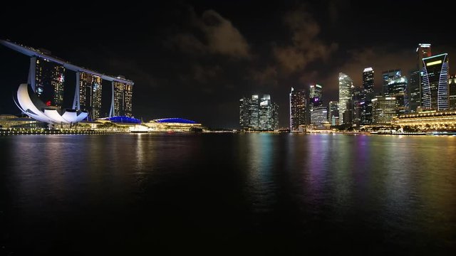 Singapore - November 27, 2017: Timelapse of Singapore cityscape in central business district with skyscrapers, Marina Sands Hotel, and ArtScience Museum at night. Shot in 4k resolution