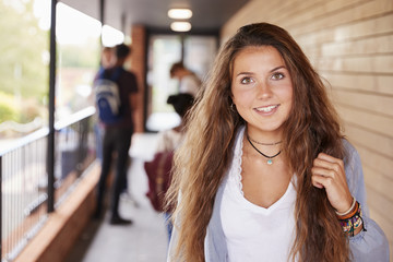 Portrait Of Female Teenage Student On College With Friends