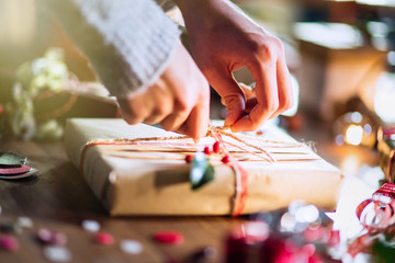 Christmas time. close-up on woman's hands wrapping a gift