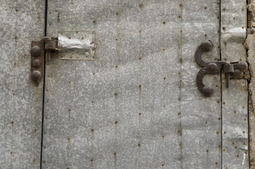 wooden door entrance with metal features.metal rounded hinge on old timber door. stone building with plank door. rusty nails on wood