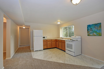 Freshly renovated L-shaped kitchen with tile flooring
