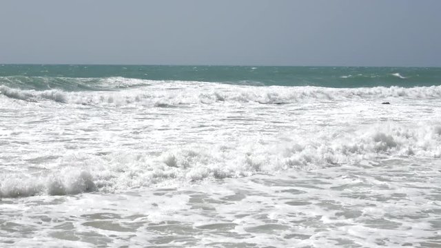 Ocean waves and sandy beach.