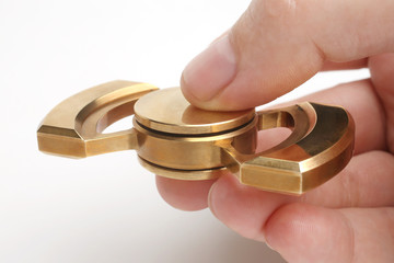 Hand holding golden fidget spinner