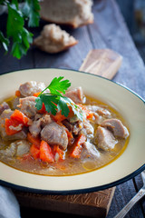 Stew of turkey thigh fillet with rustic vegetables, selective focus
