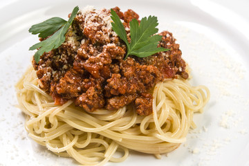 Italian spaghetti pasta with beef and tomato sauce bolognese on white plate