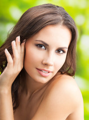 Happy smiling woman with long hair, outdoors