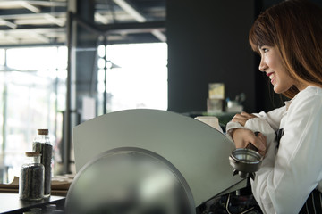 small business owner standing at counter in coffee shop. female barista wearing apron smiling at bar in cafe. food service, restaurant concept.