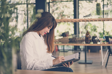 start up woman work in cafe. female student  write note in notebook in coffee shop. education, lifestyle, business, people concept.