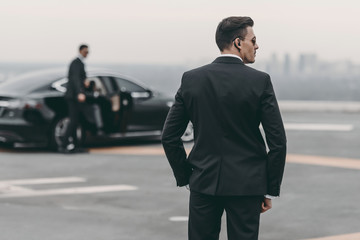 rear view of bodyguard in suit and sunglasses