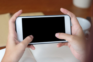 Woman hands using smart phone with blank screen background for mock up, template, technology and lifestyle concept