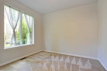 Empty room with carpet floor and cream walls
