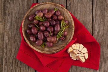 Overhead view of olives with rosemary in bowl