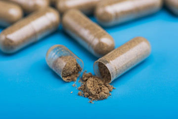 Herbal pills on a blue