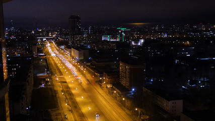 Fototapeta na wymiar Light trails on the modern building. The life of the city at night with traffic. Concept of night life